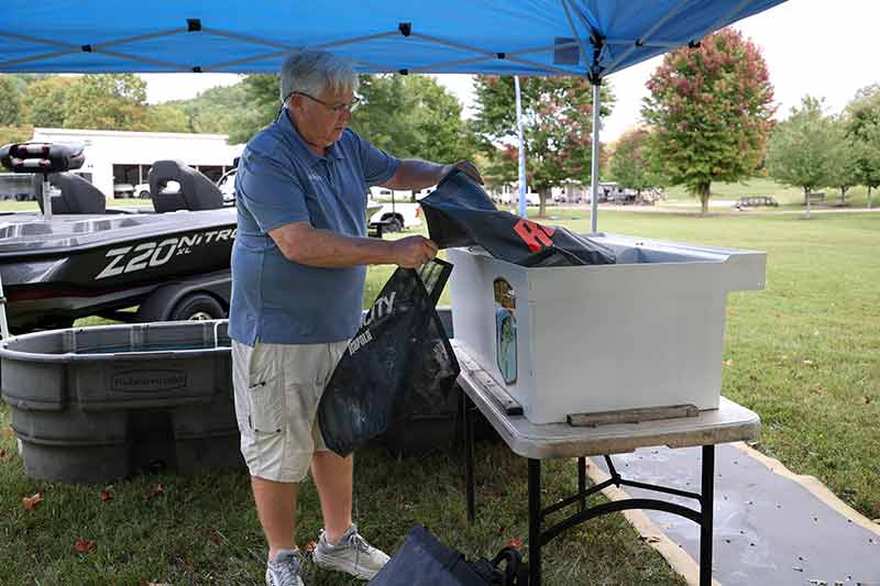 Mike Phillips prepares fish bags for returning anglers