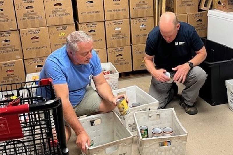 Two volunteers packing up food during 92nd anniversary Week of Service