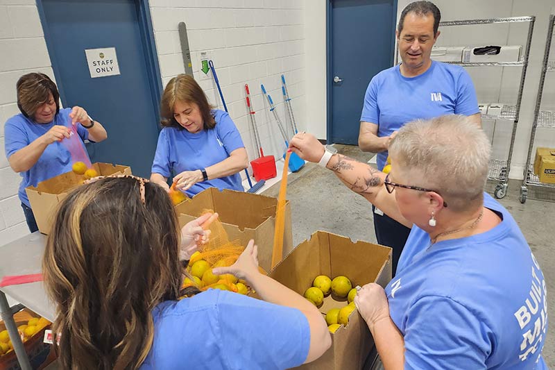 92nd anniversary Week of Service volunteers package food into boxes