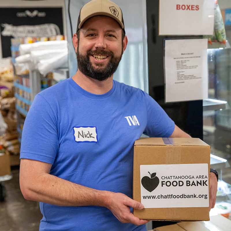 TVA employee with Chattanooga Area Food Bank box