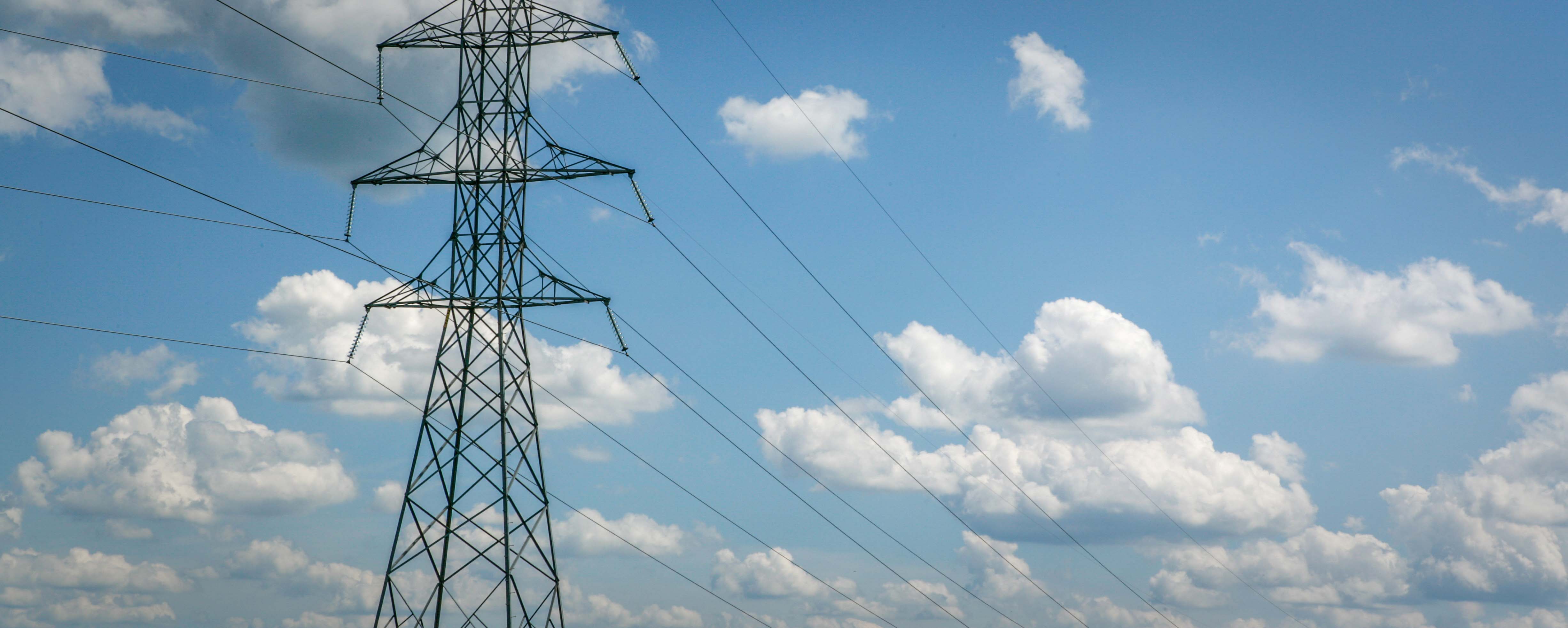 sustainability-hero-_B7J1244 transmission tower with clouds
