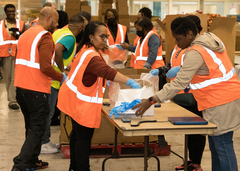 Volunteers of TVA and MLGW employees packaging food