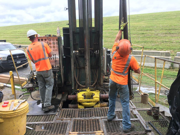 workers drilling a well