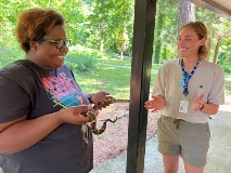 Sara Bayles and participant with snake