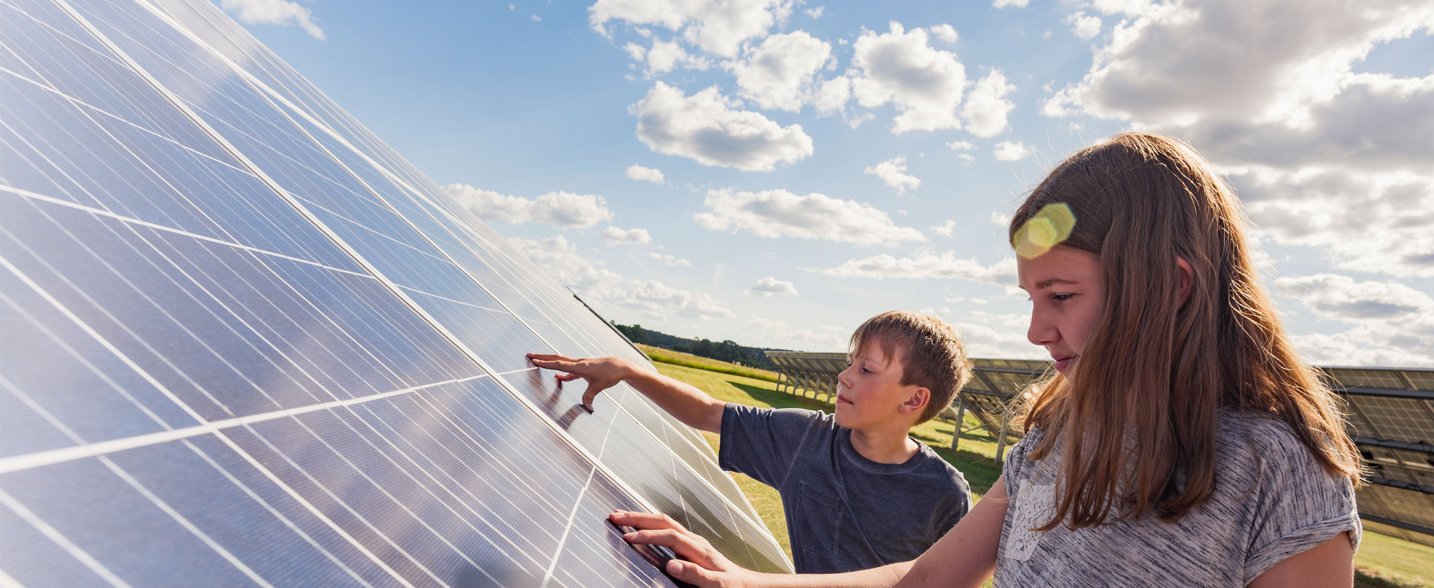 Sustainability Kids touching solar panel