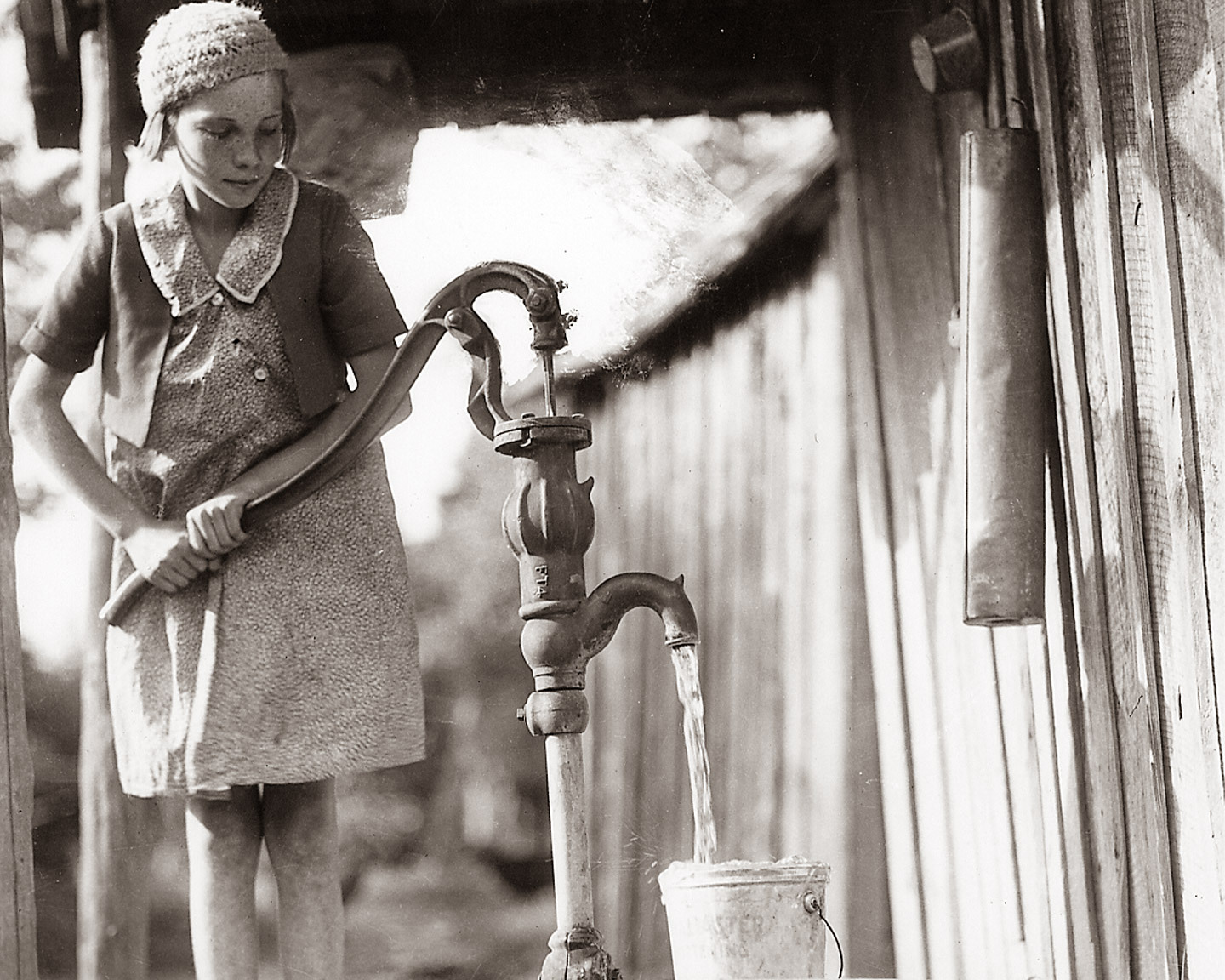 Girl pumping water