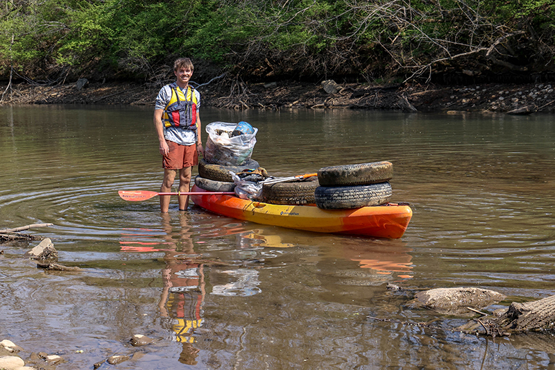 Boy cleaning the river